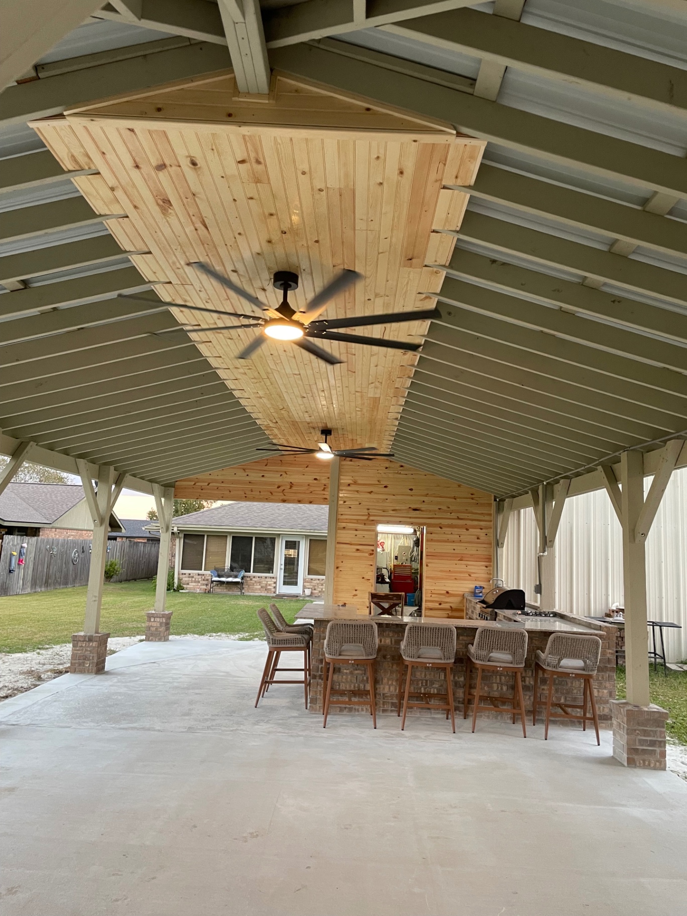 Mudbug Construction crew mid-project on a two-story Louisiana home — siding and framing in progress